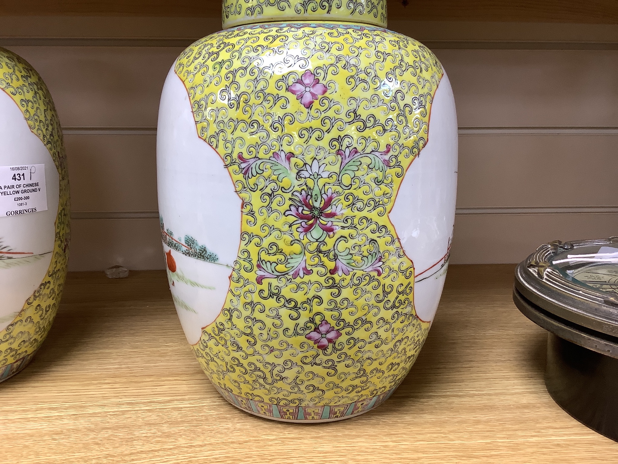 A pair of Chinese yellow ground vases and covers, height 30cm